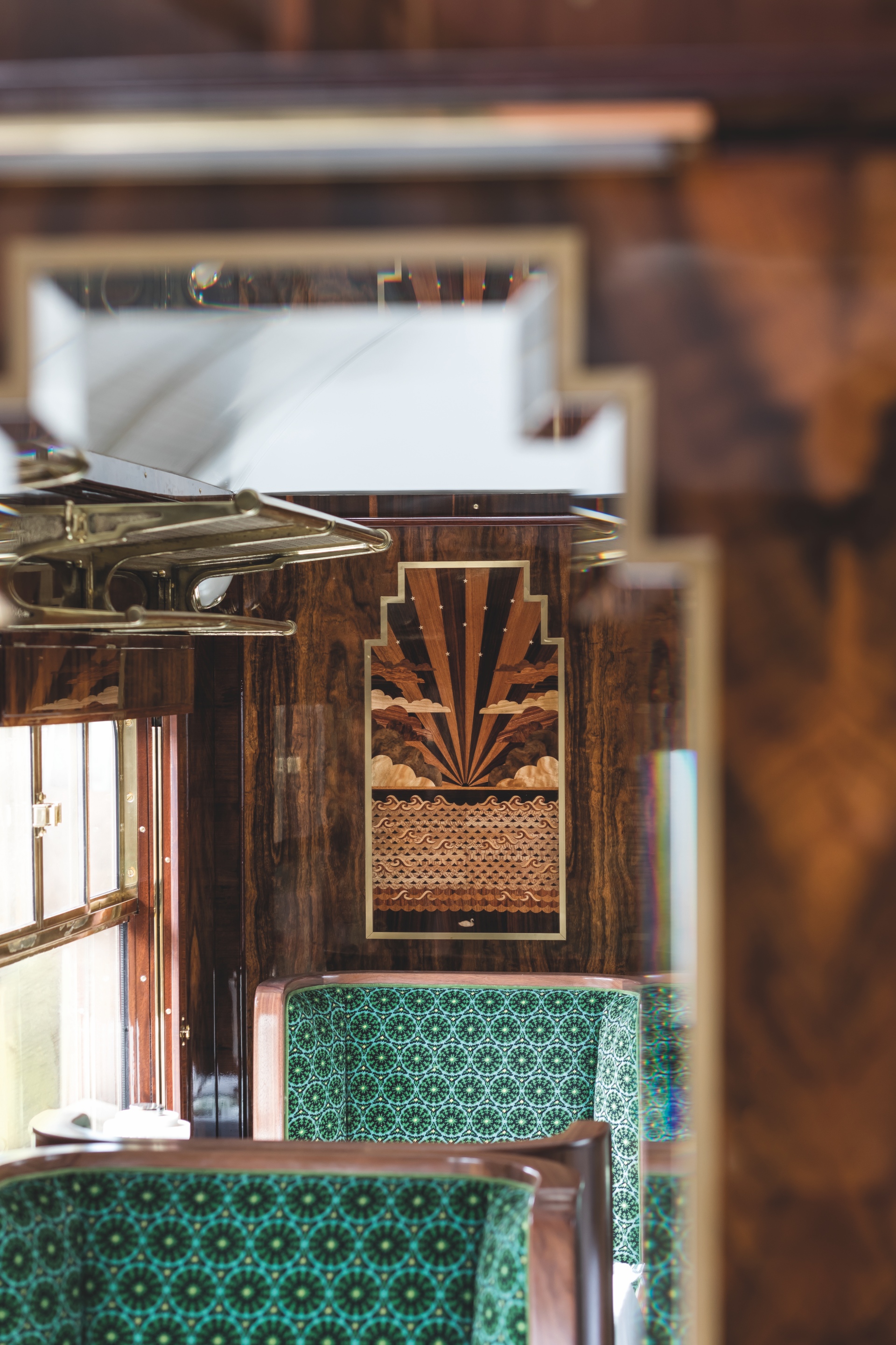 Close-up of heat-sand shaded wood inlay details inside a restored British Pullman train car
