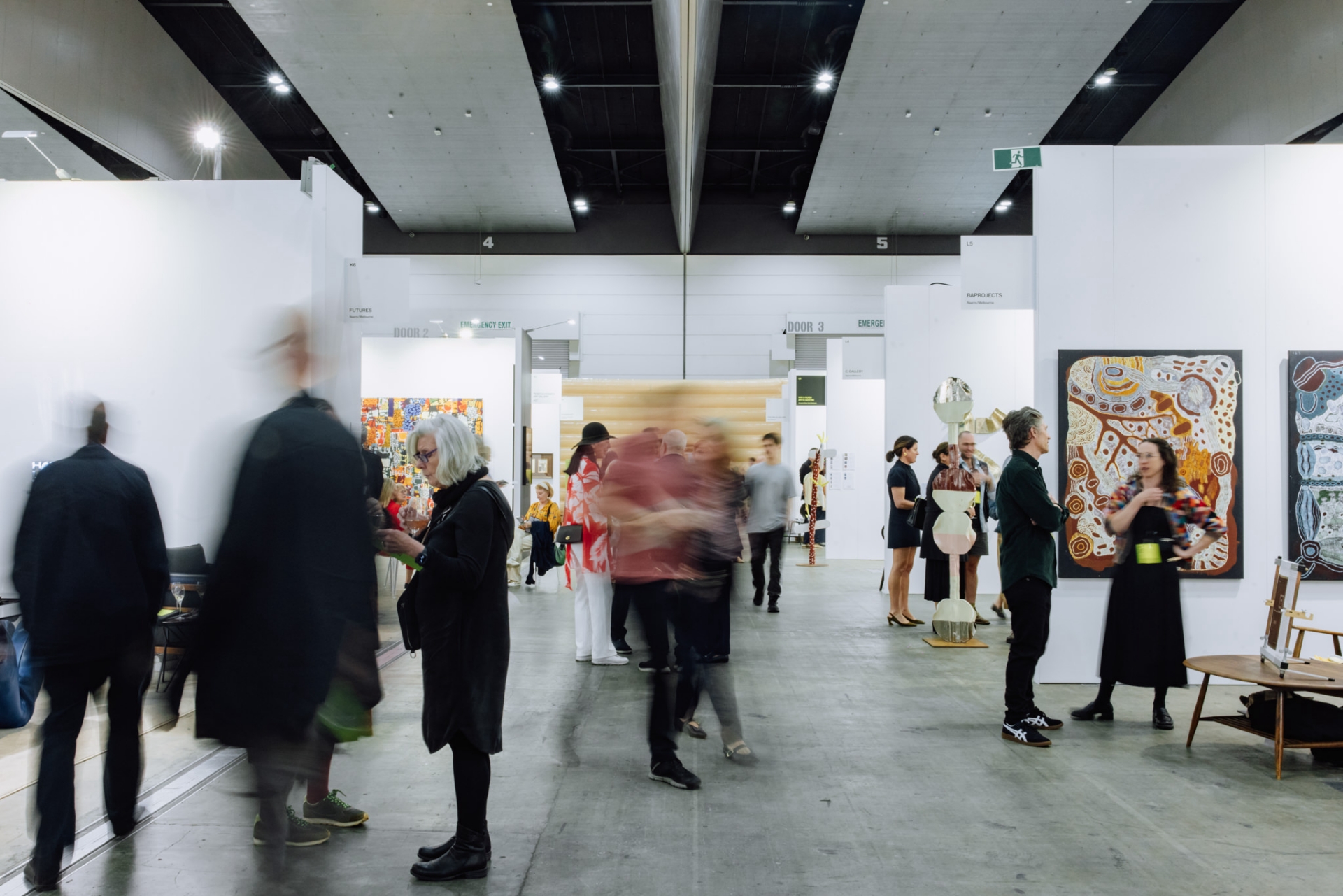 Visitors engage with contemporary artworks and curated presentations at the Melbourne Art Fair