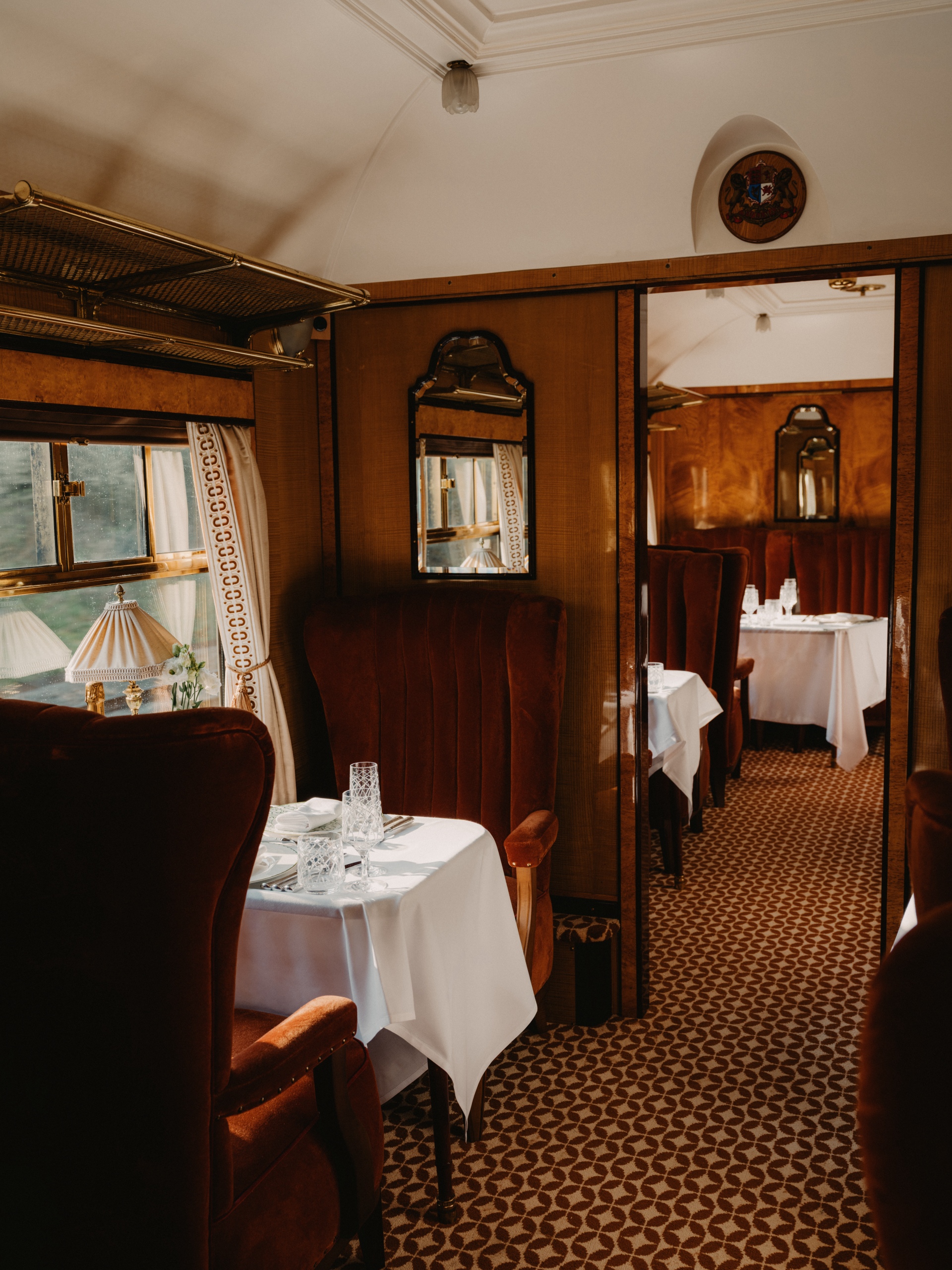 Intimate seating area in the carriage showing plush velvet seats and brass wall lamps