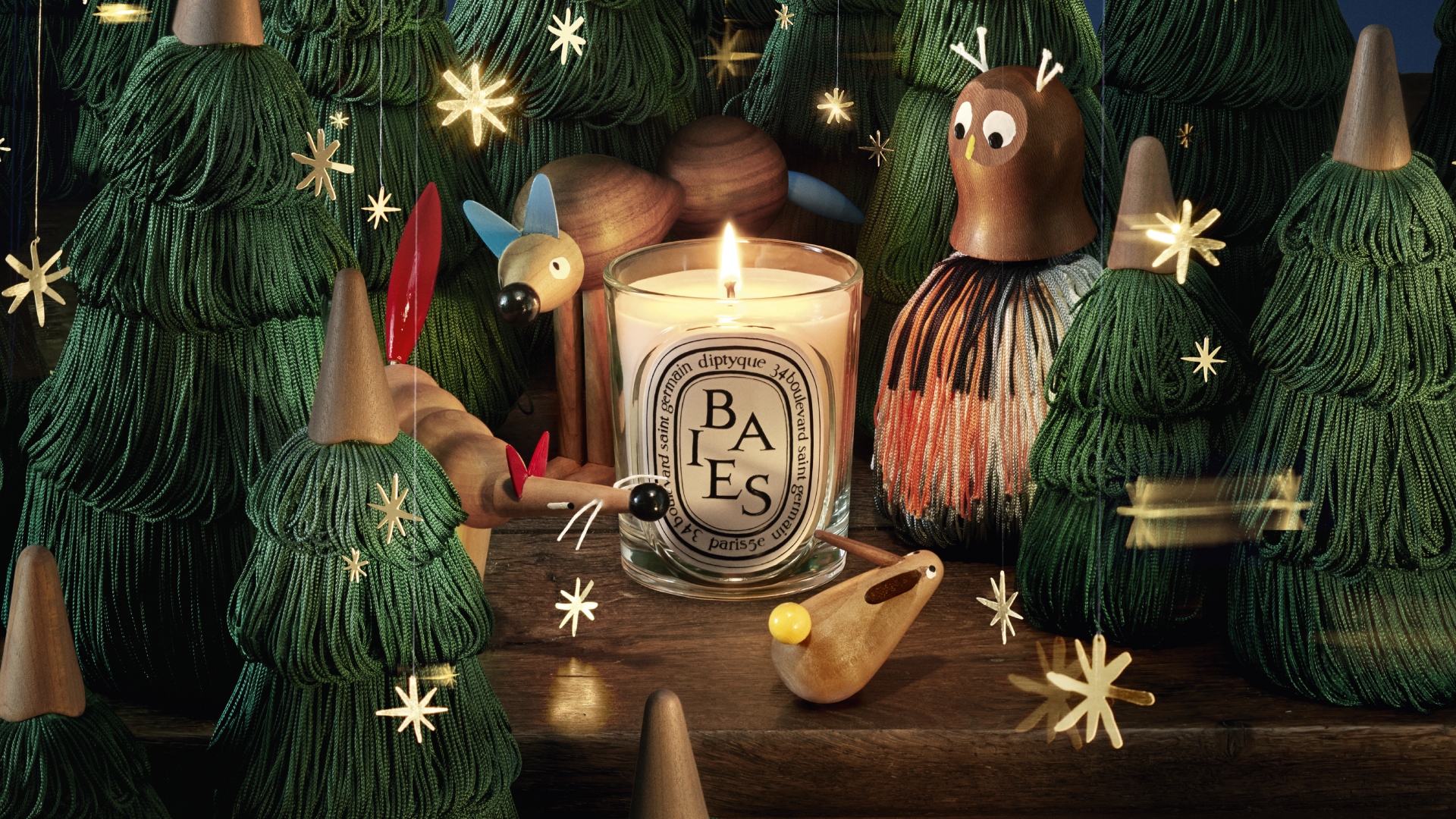 Close-up of a handcrafted wooden owl and tree figurine from Jean-Simon Roch’s enchanted forest collection for Diptyque.